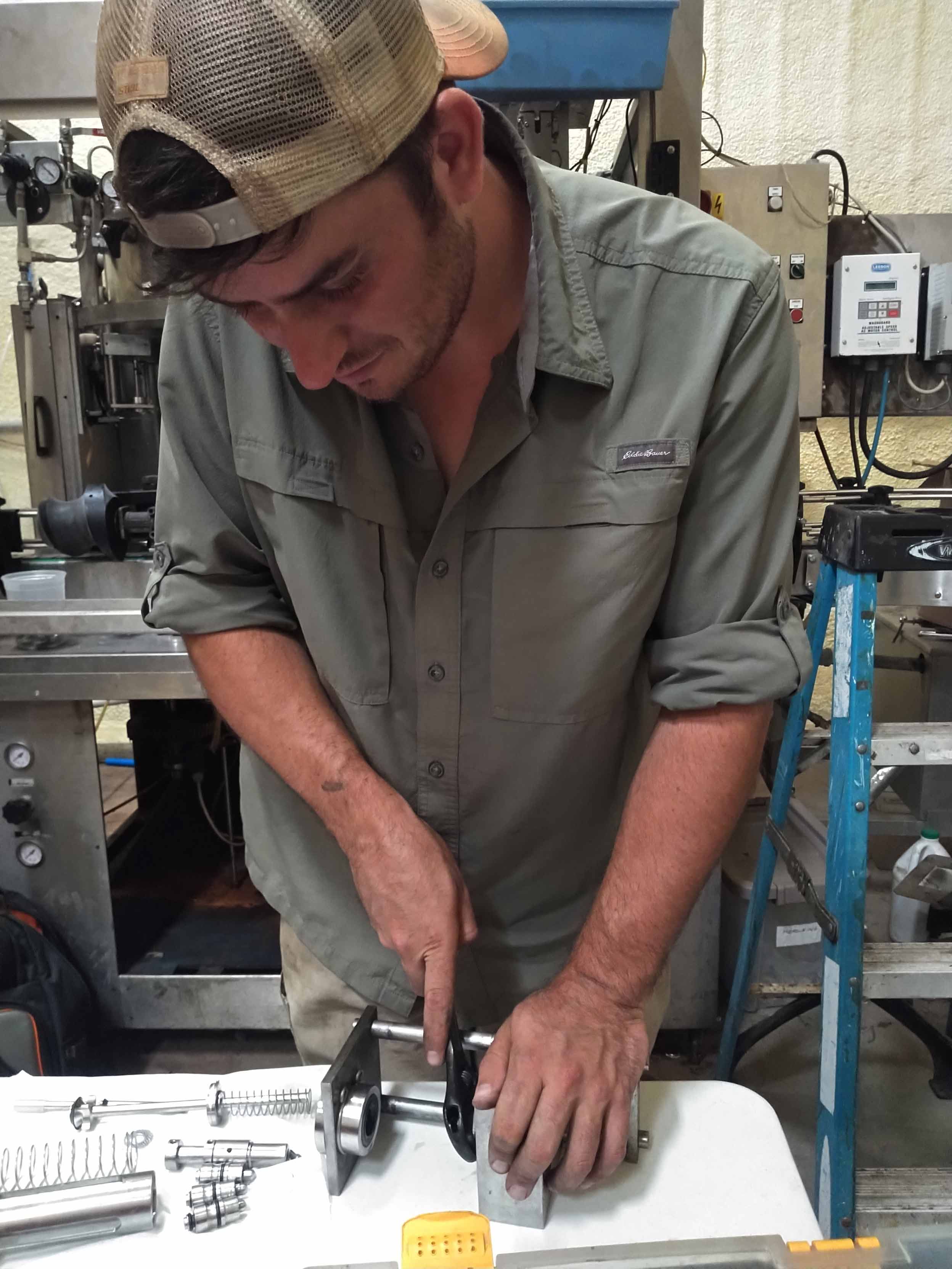 Nicholas Giampietro using a vintage adjustable wrench for farm maintenance. 
