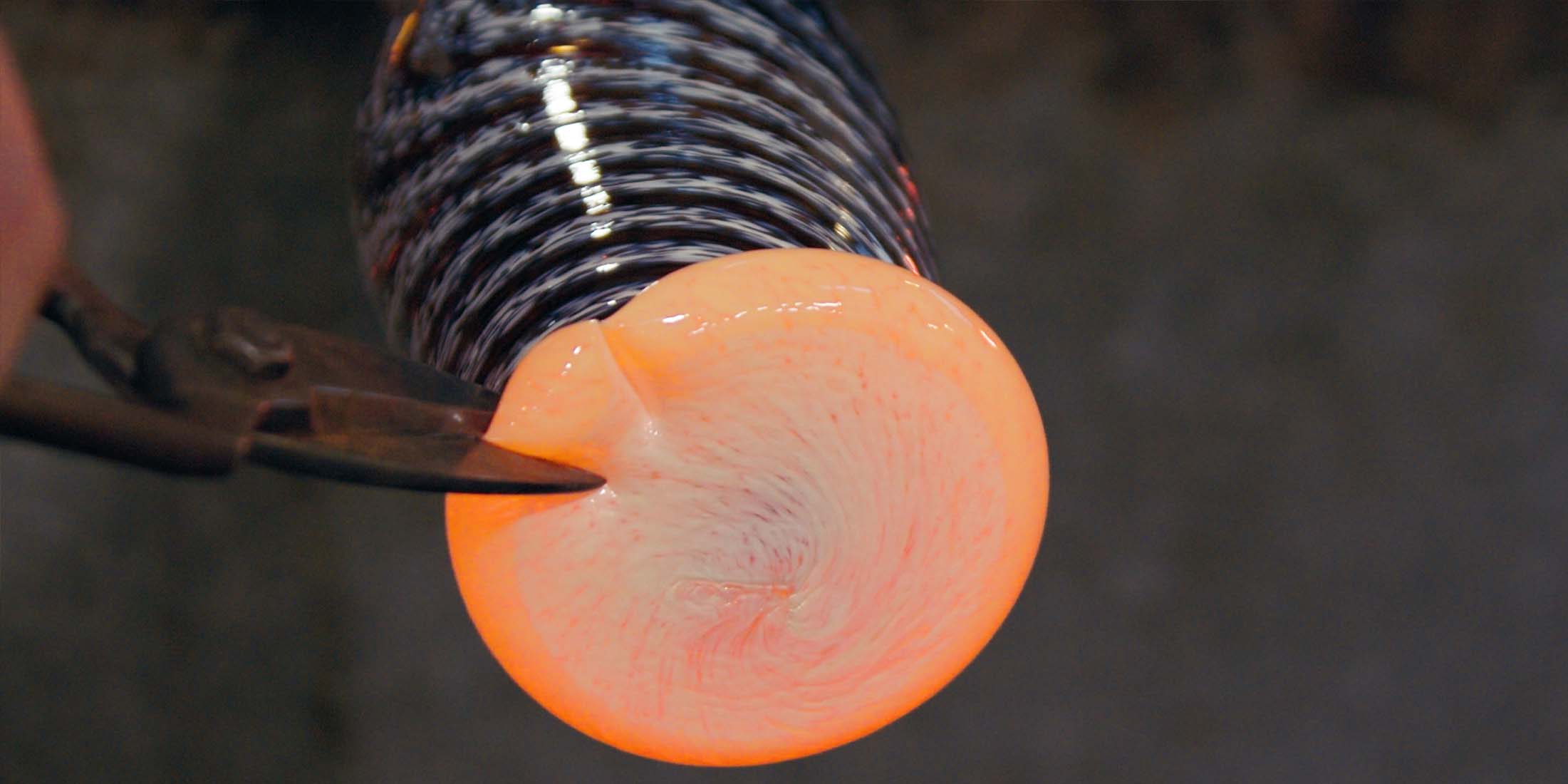 Glassblower shaping a footer