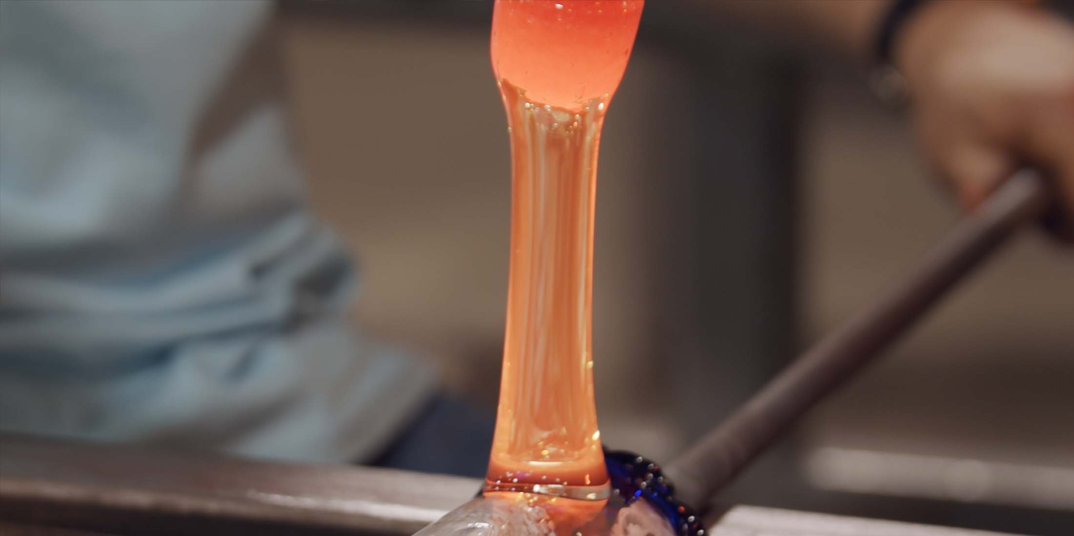 Glassblower shaping a handle