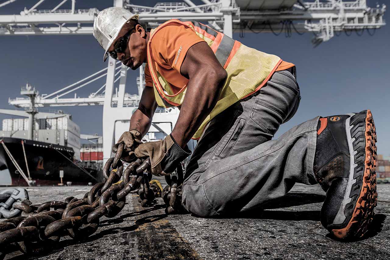 Man working on oil rig showing safety shoes